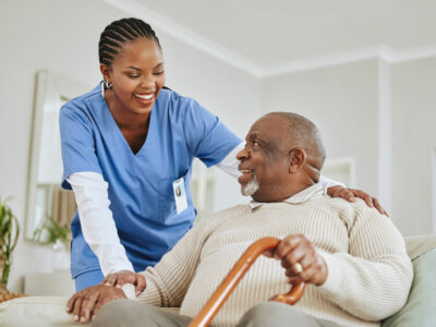 Health care provider warmly interacting with senior female patient